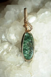 Close-up view of 14K Gold-Filled green Seraphinite Wire-Wrapped Pendant, showcasing exquisite design and the calming beauty of seraphinite crystal